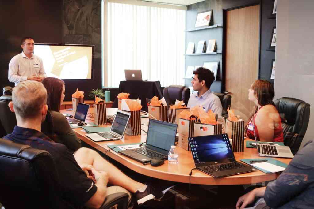 A business leader presenting to his team around a boardroom table