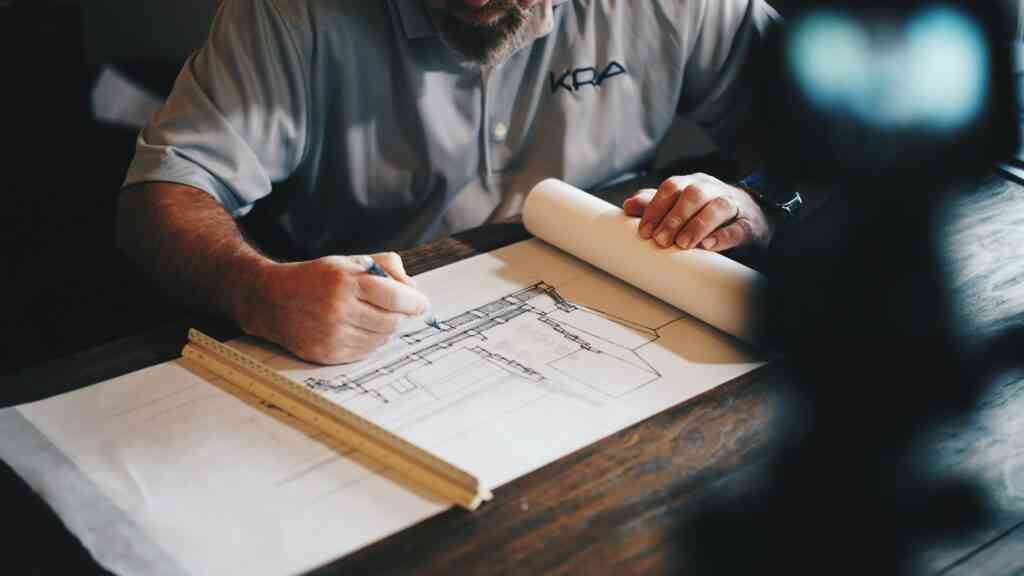 A business owner sketching plans at a desk